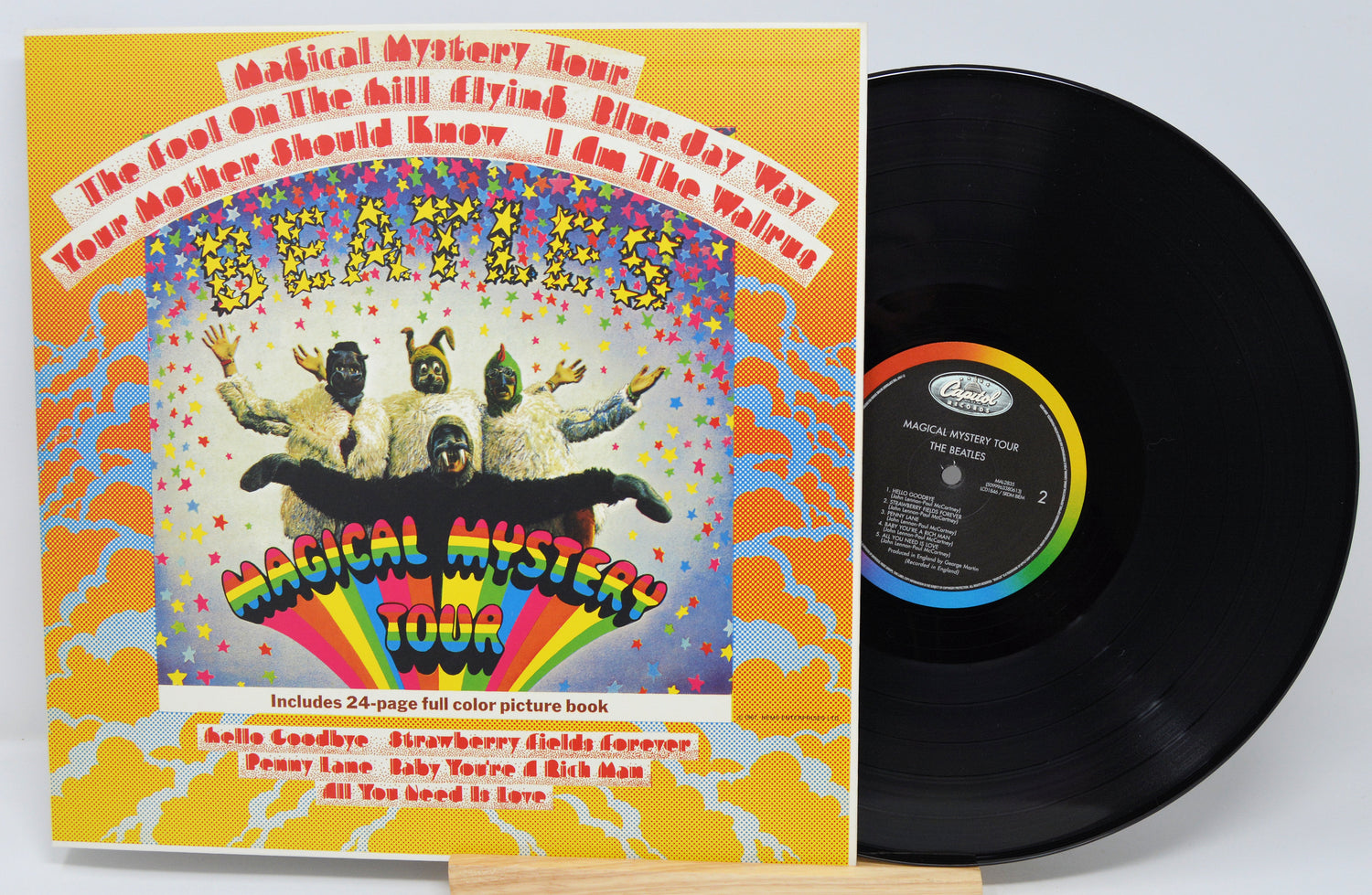 Vinyl record and cover of The Beatles' 'Magical Mystery Tour' album on a white background