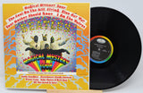 Vinyl record and cover of The Beatles' 'Magical Mystery Tour' album on a white background