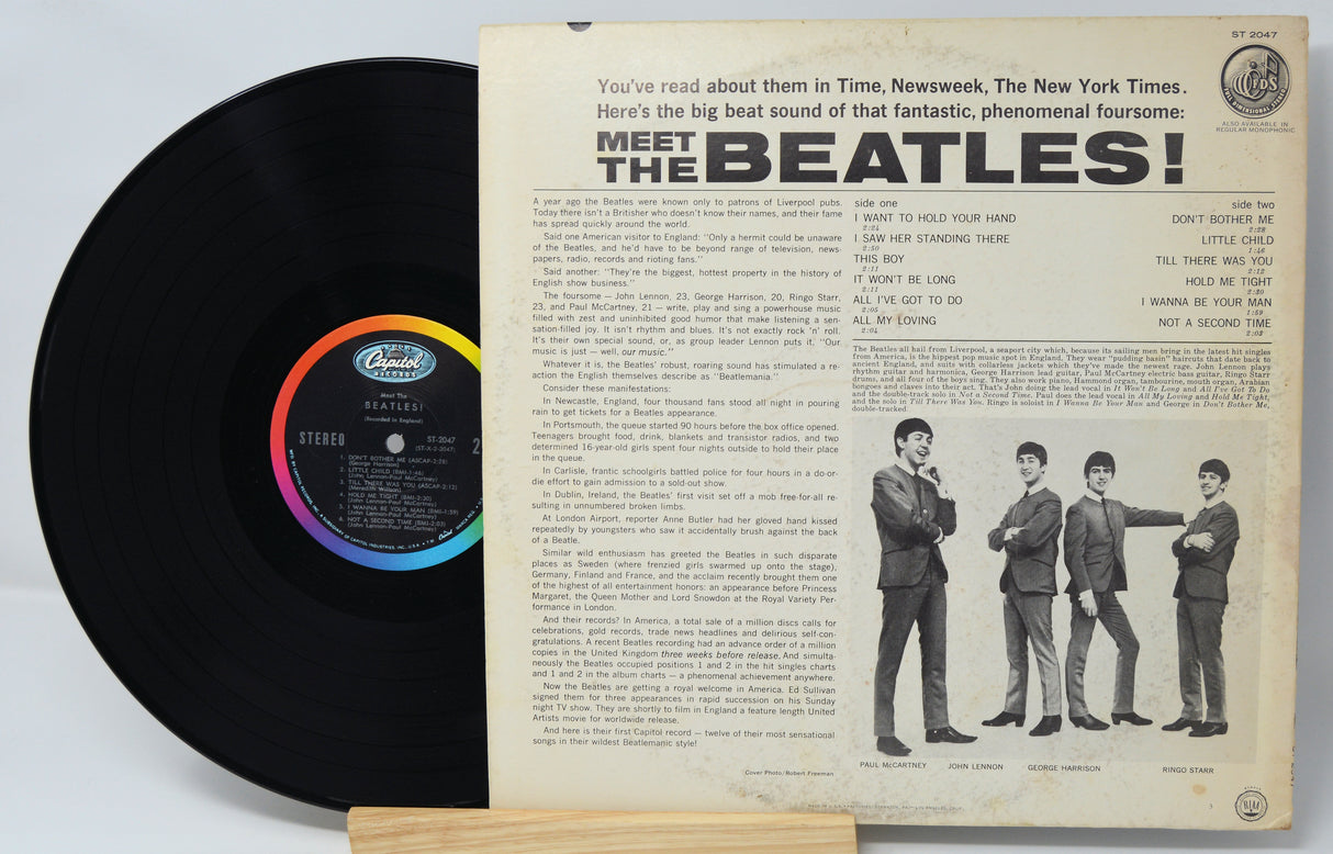 Vinyl record with its cover featuring 'Meet the Beatles!' text and band members.