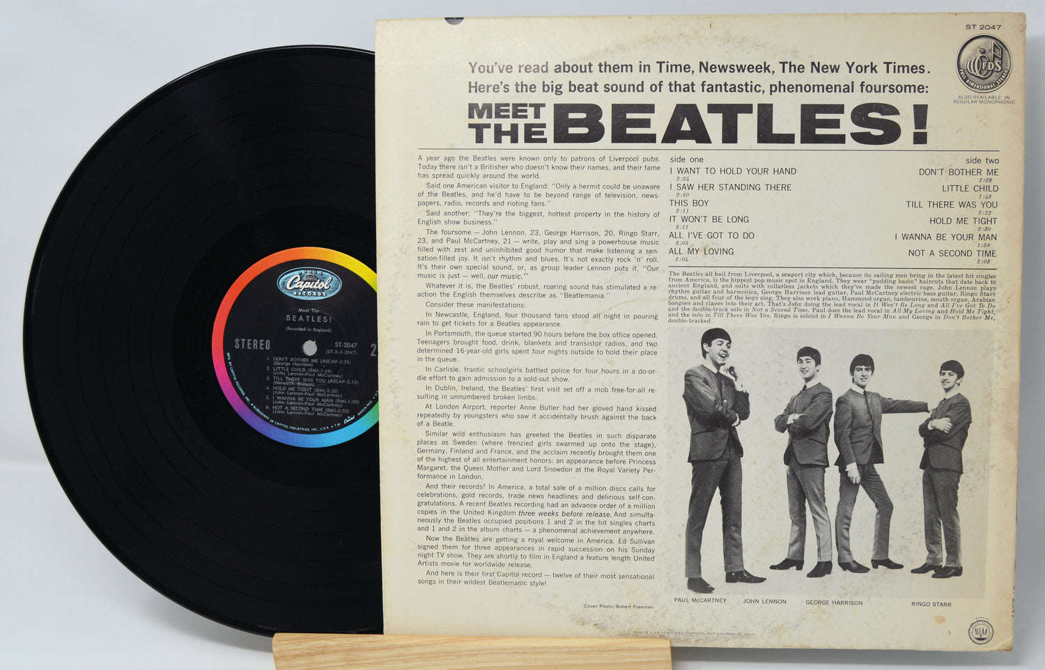 Vinyl record with its cover featuring 'Meet the Beatles!' text and band members.