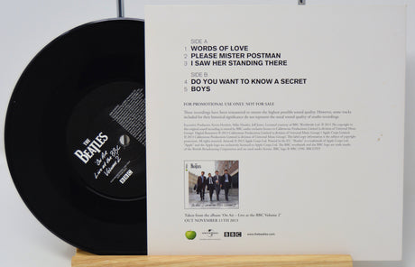Vinyl record with cover featuring The Beatles text and image