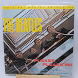 Vinyl record cover for 'Please Please Me' by The Beatles with yellow text and a photo of the band members.