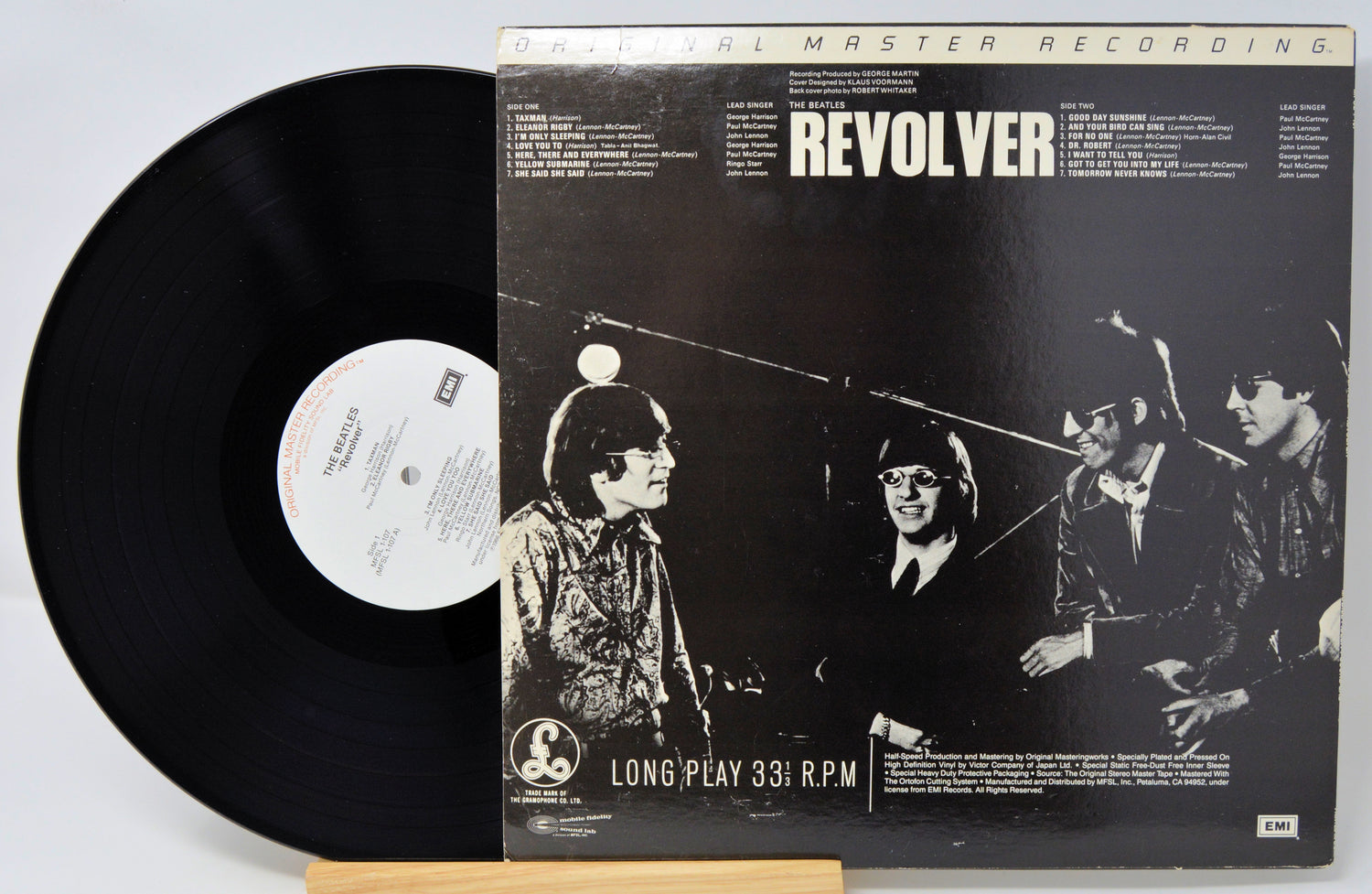 Vinyl record and cover of 'Revolver' by The Beatles on a white background