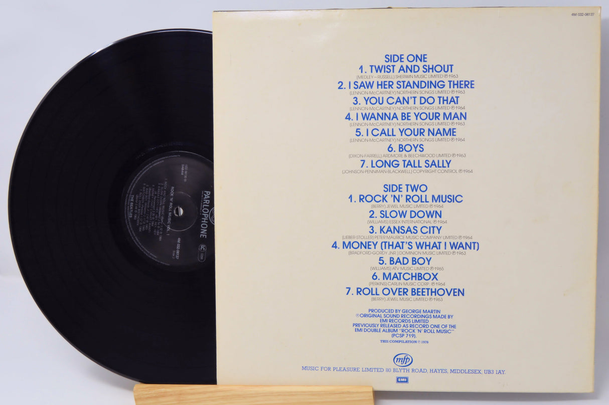 Vinyl record with cover displaying tracklist on a light gray background