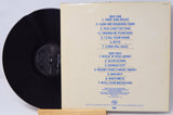 Vinyl record with cover displaying tracklist on a light gray background