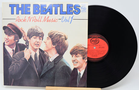 Vinyl record and cover featuring The Beatles with a white background