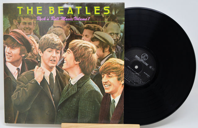 Vinyl record and cover featuring The Beatles on a white background