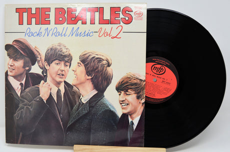 Vinyl record with cover featuring The Beatles and text 'The Beatles Rock N Roll Music Vol 2'.