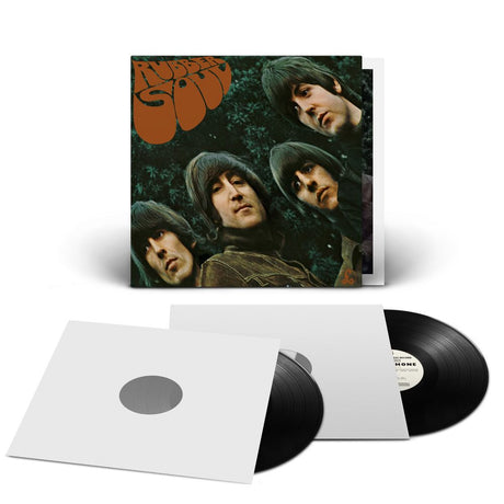 A vinyl record album set displayed on a white background, featuring a square album cover with a dark green portrait collage and orange text, a white outer sleeve, and two black LP records partially pulled from the sleeve.