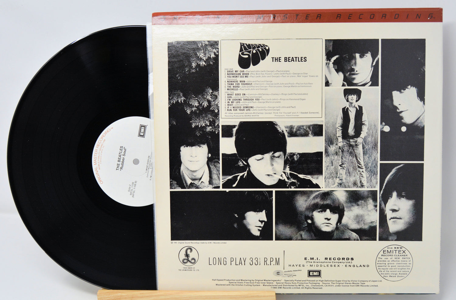 Vinyl record with cover featuring black and white images of a band member, on a light gray background.