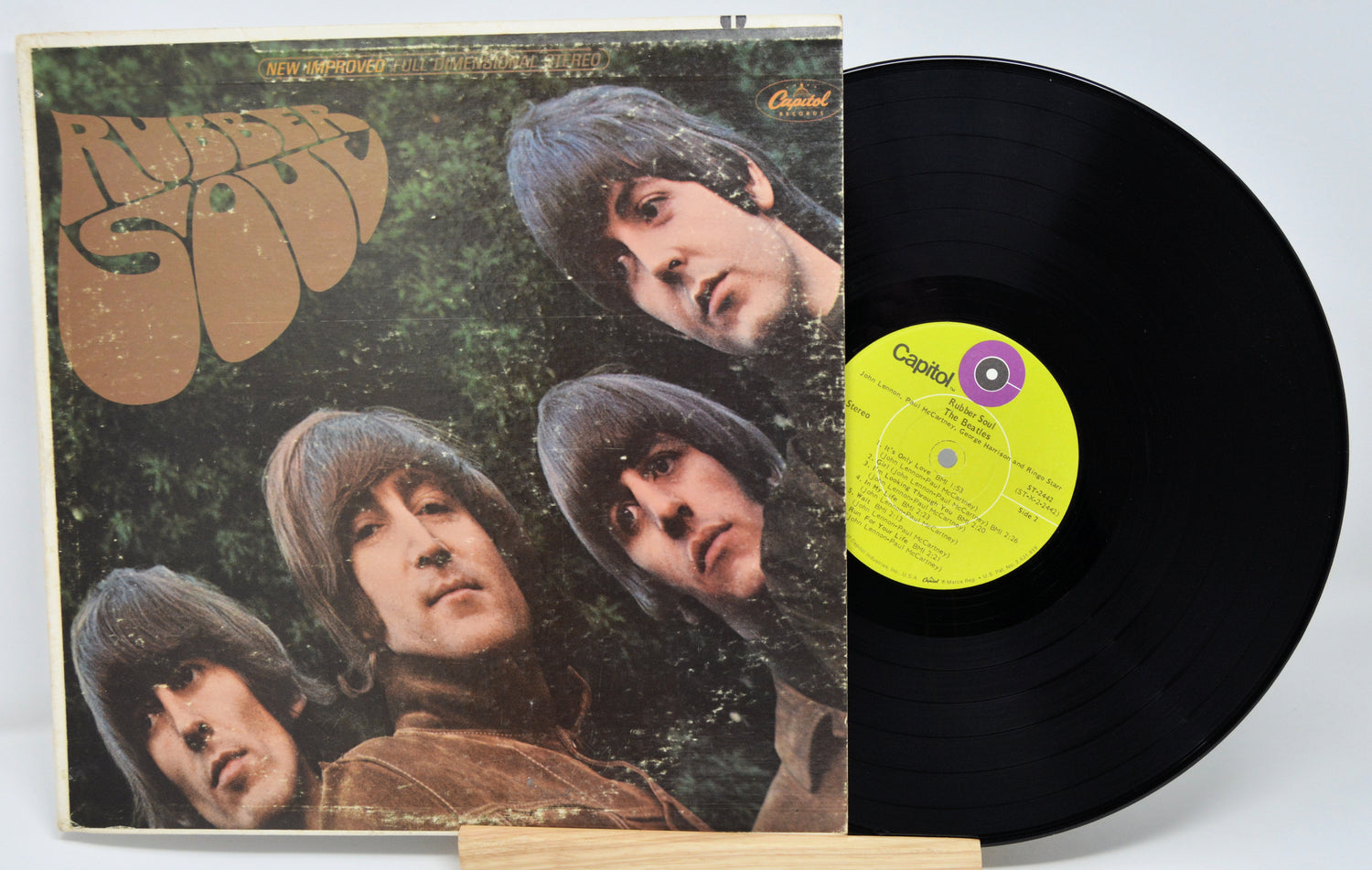Vinyl record with cover featuring four band members and a visible label.