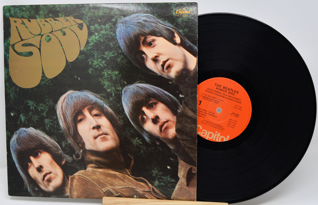 Vinyl record with cover featuring The Beatles' 'Rubber Soul' on a white background