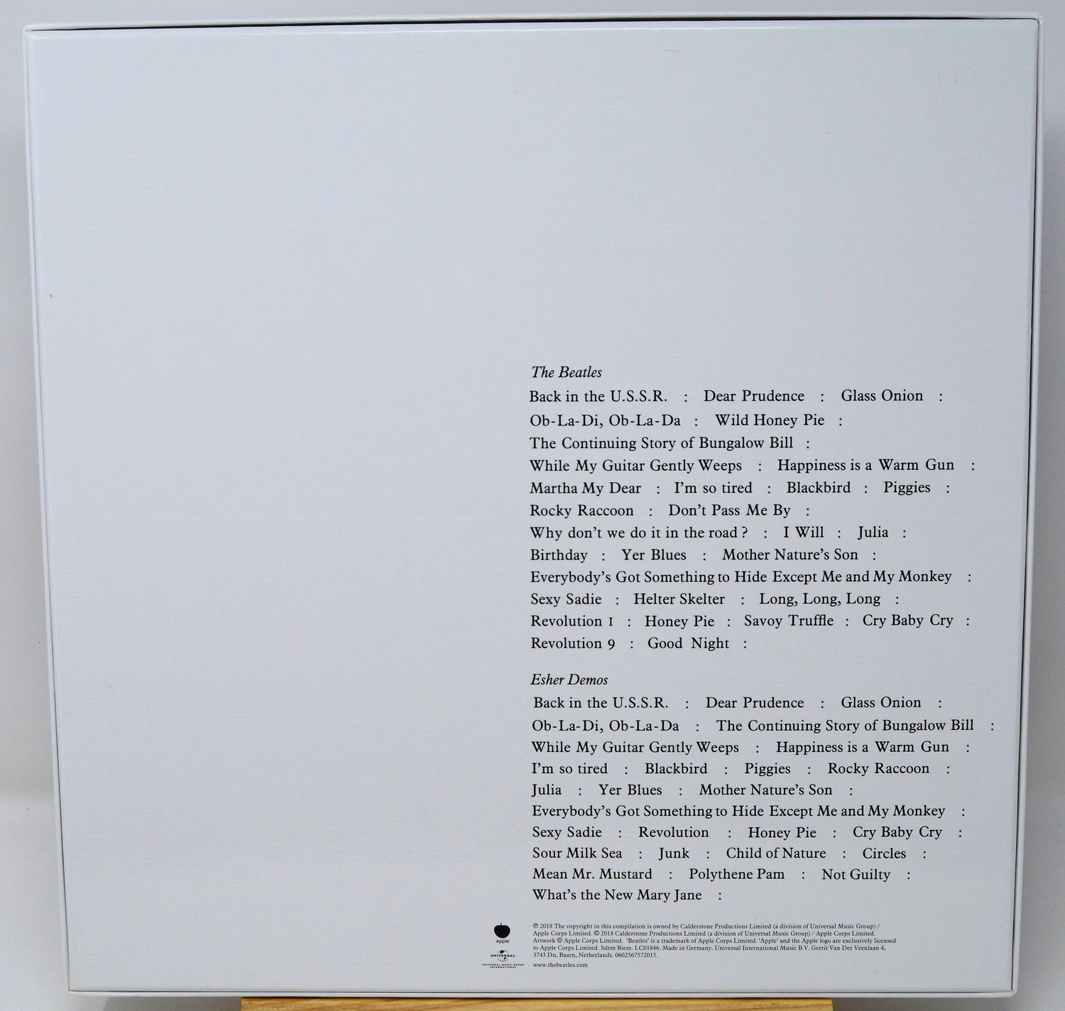 Back cover of a music album with tracklist on a white background