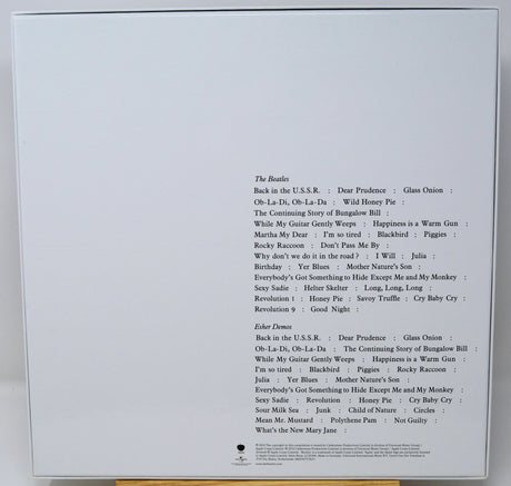 Back cover of a music album with tracklist on a white background