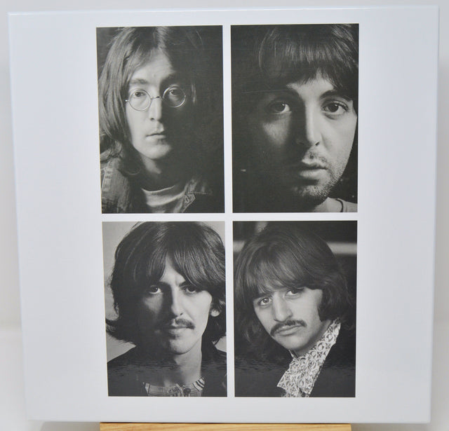 Black and white portraits of four individuals arranged in a 2x2 grid on a light background.