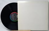 Vinyl record with a white cover on a light gray background