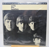 Vinyl record cover with black and white photo of four individuals and text 'with the beatles' on a beige background.