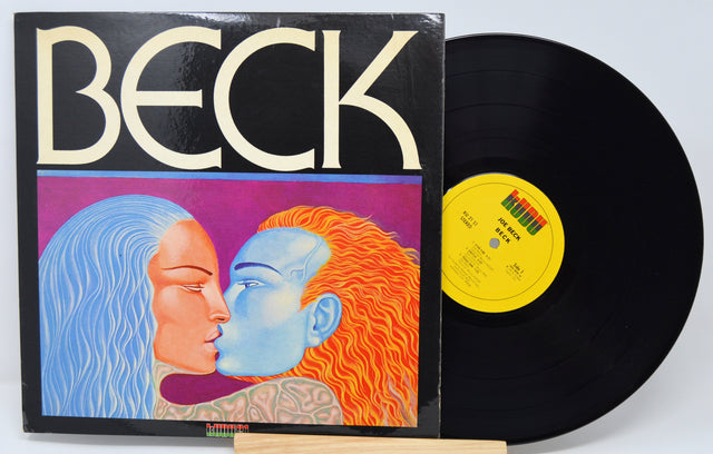 Vinyl record with cover featuring abstract faces and 'Beck' branding.