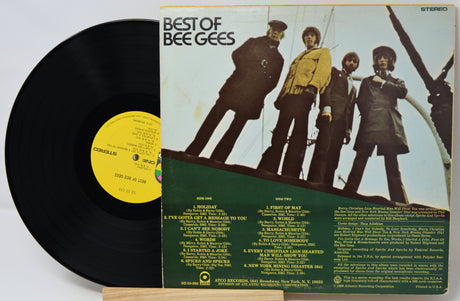 Vinyl record with cover featuring a group of people on a boat, labeled 'Best of Bee Gees'.