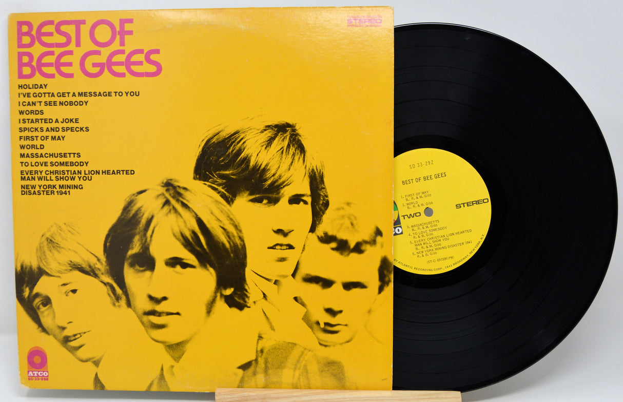 Vinyl record and cover of 'Best of Bee Gees' on a white background