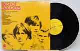 Vinyl record and cover of 'Best of Bee Gees' on a white background