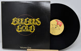 Vinyl record and cover with 'Beelze Gold Volume One' text on a white background