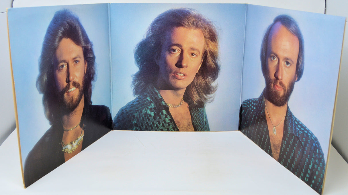 Triple album cover with three portraits of a person on a blue background