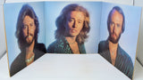 Triple album cover with three portraits of a person on a blue background