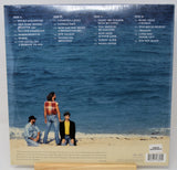 Vinyl record sleeve with beach scene and tracklist