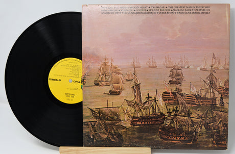 Vinyl record with a ship-themed cover on a light gray background