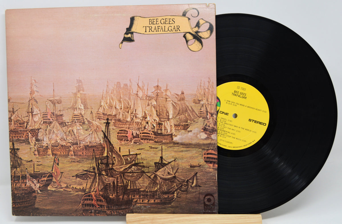 Vinyl record with a detailed cover illustration of ships and text 'Bee Gees Trafalgar'.