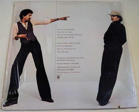 Back cover of Bell & James album with tracklist and duo striking disco poses