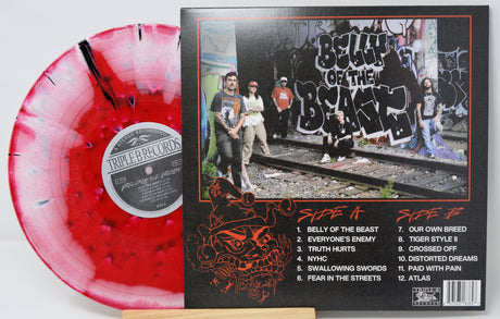 Combust Belly of the Beast vinyl with red splatter pattern next to graffiti-style band photo and tracklist