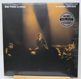 Ben Folds w/ y'music 'In Concert 2015-2016' vinyl record album, sealed in plastic shrink wrap, displayed on a wooden stand against a white background.