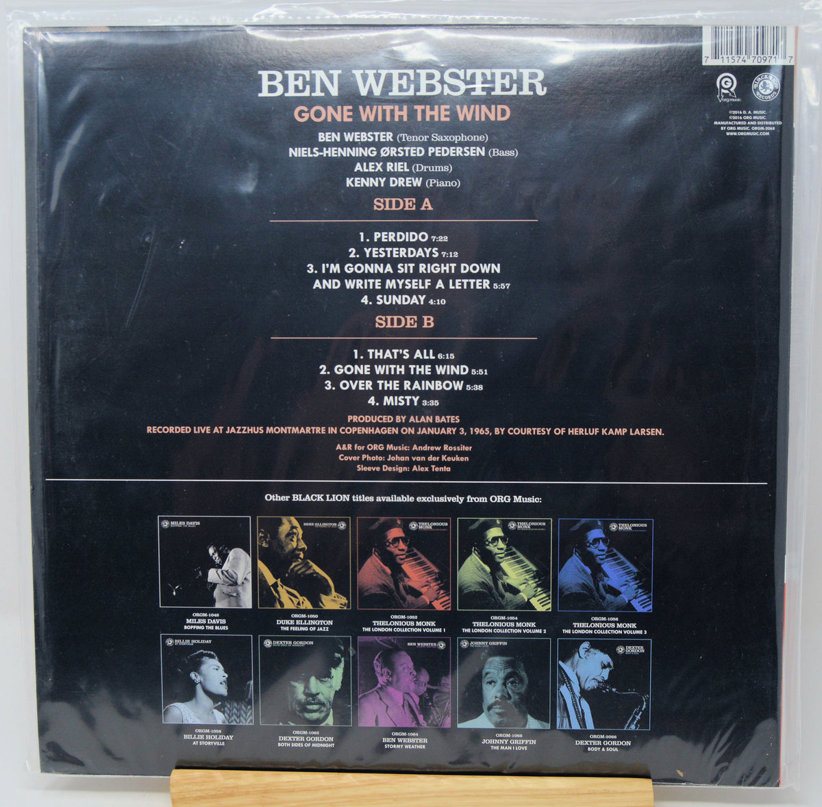 Back cover of a Ben Webster 'Gone With the Wind' vinyl record in clear plastic shrink-wrap, photographed flat against a light background. The cover shows track listings, artist credits, and a row of small color portraits along the bottom.