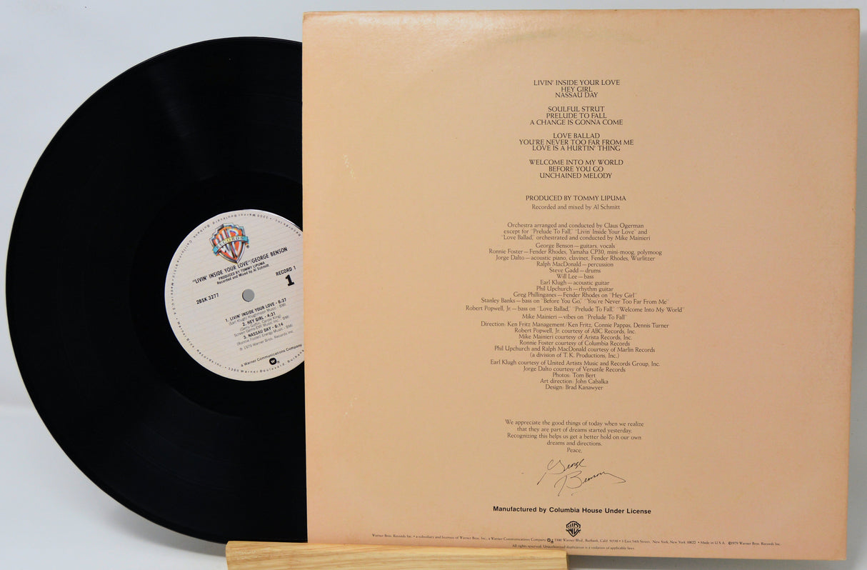 Vinyl record with a beige label and text on a white background