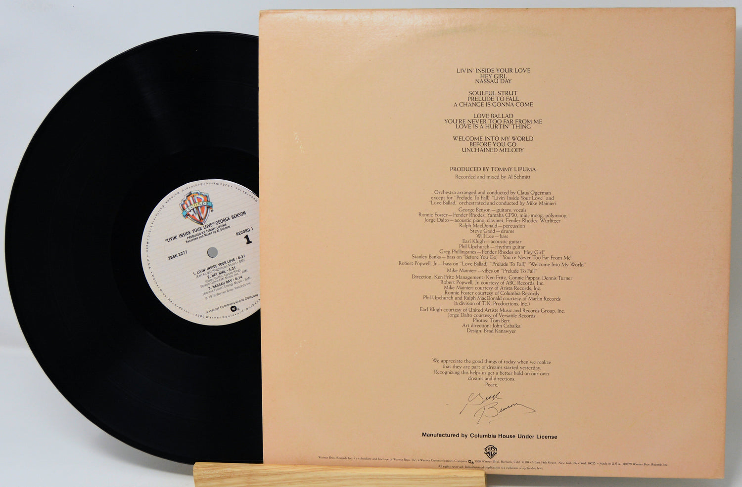Vinyl record with a beige label and text on a white background