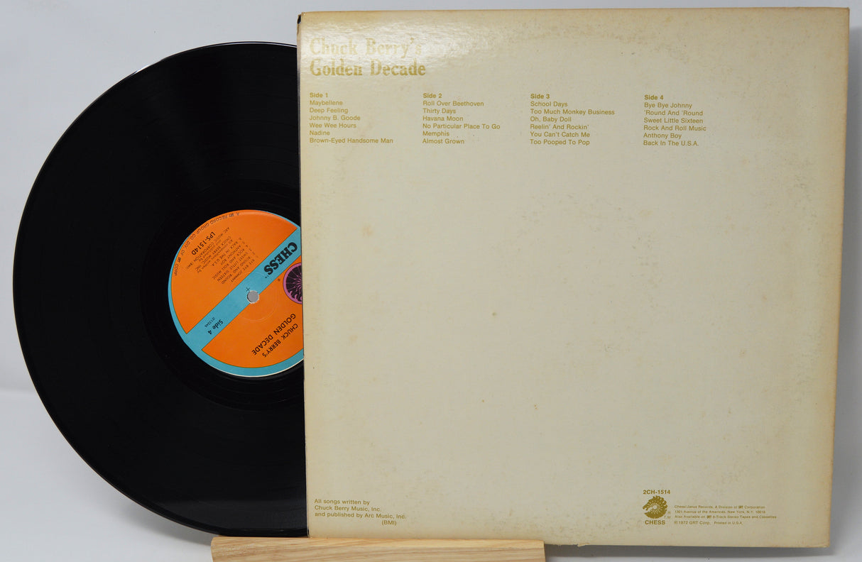Vinyl record with orange label and beige record cover on a white background