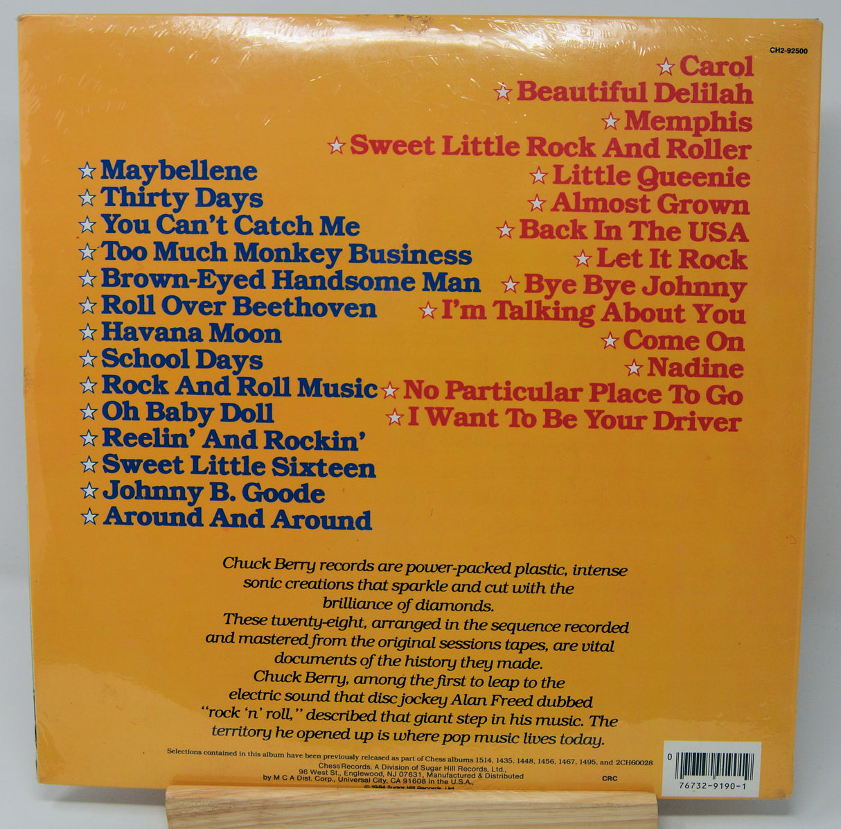 Back cover of a vinyl record with song list and text on a yellow background
