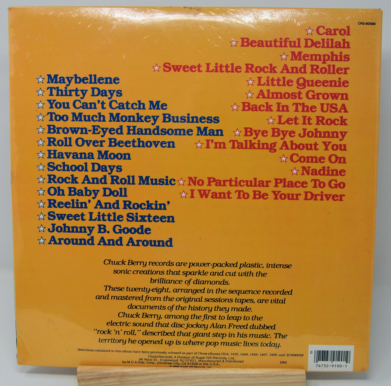 Back cover of a vinyl record with song list and text on a yellow background