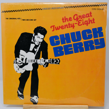 Vinyl record cover featuring a stylized illustration of a man playing guitar with 'The Great Twenty-Eight Chuck Berry' text on an orange background.