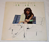 Vinyl record cover with a person sitting on a bench holding a green object, with 'Loredana Berté' text at the top.