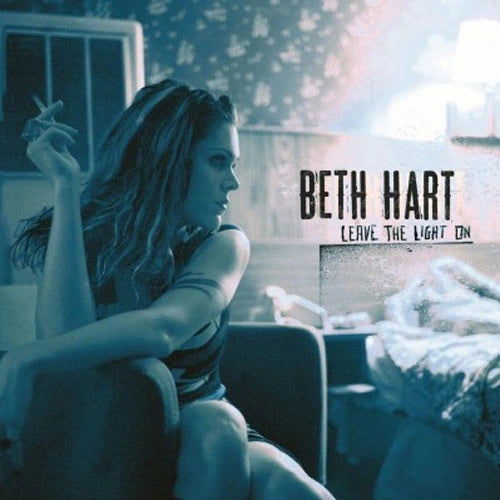 Album cover art for Beth Hart's 'Leave the Light On', featuring a woman sitting in a dimly lit room with a cigarette, tinted blue lighting, and the artist's name and album title in text on the right.