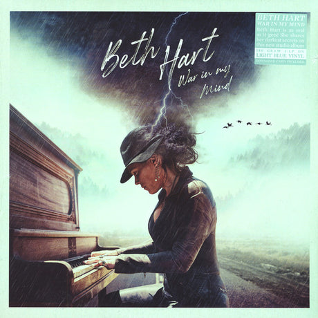 Album cover featuring a woman playing piano with a stormy background and text 'Beth Hart War in my Mind'.
