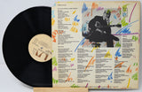 Vinyl record with colorful cover featuring a guitarist and text