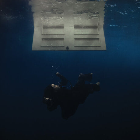 Billie Eilish 'Hit Me Hard And Soft' showing a person underwater looking up at a submerged door