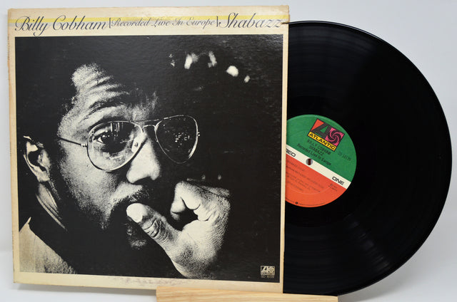 Vinyl record album 'Recorded Live in Europe's Shabbat' by Billy Cobham, showing the front cover with a black-and-white portrait and the black record partially pulled out on a light background.