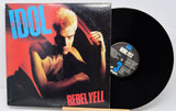 Vinyl record with cover featuring a person and 'Rebel Yell' text on a white background
