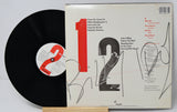 Vinyl record with cover displaying album art and text