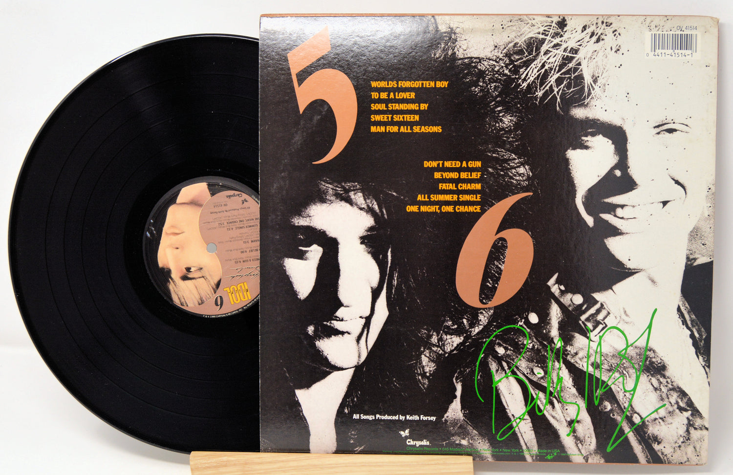 Vinyl record with a cover featuring two faces and the number '56'.